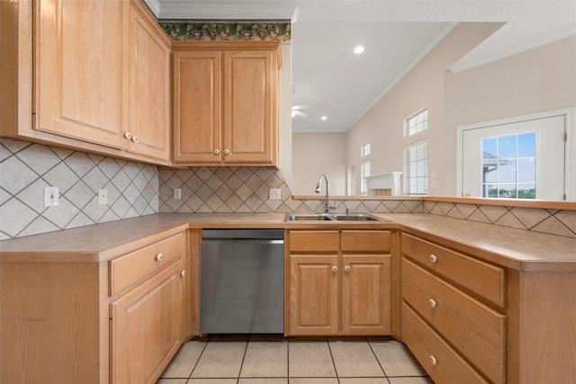 kitchen featuring a peninsula, dishwasher, ornamental molding, and a sink