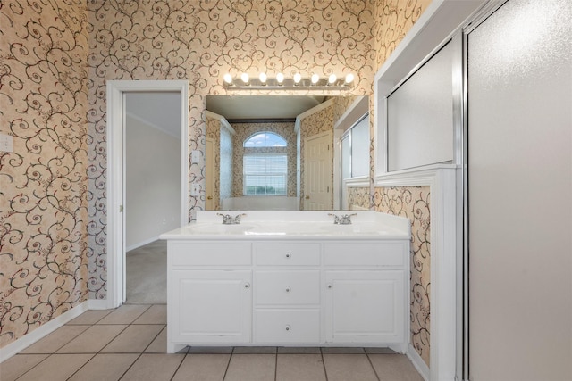full bathroom featuring wallpapered walls, baseboards, and a sink