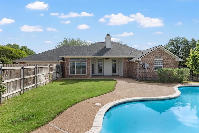 view of swimming pool featuring a lawn, a fenced backyard, and a fenced in pool