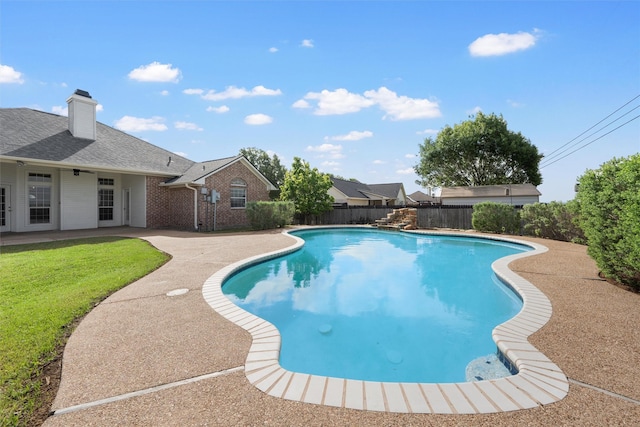 view of swimming pool with a fenced backyard, a patio area, a yard, and a fenced in pool