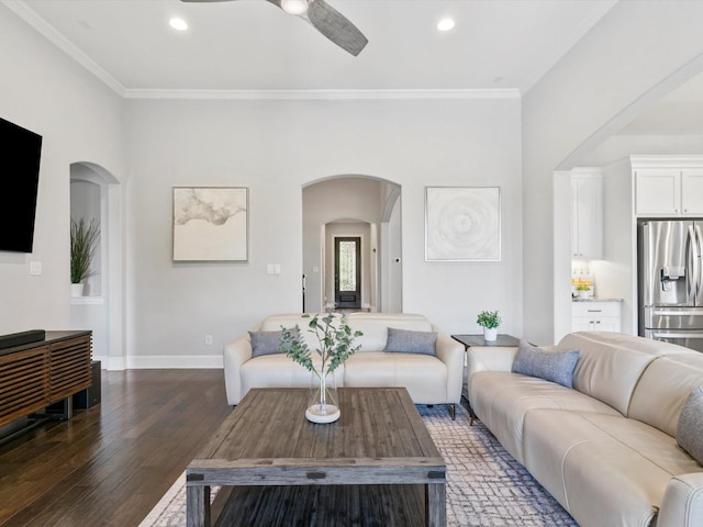 2908 Ballater Ct, The Colony, TX 75056 - living room featuring arched walkways, a ceiling fan, dark wood-style floors, crown molding, and recessed lighting