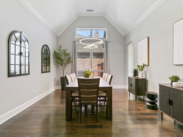 2908 Ballater Ct, The Colony, TX 75056 - dining room featuring arched walkways, dark wood-type flooring, vaulted ceiling, a chandelier, and baseboards