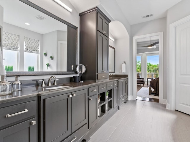 bathroom featuring a sink, a ceiling fan, double vanity, and visible vents
