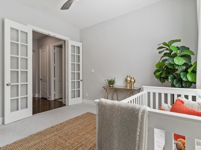 carpeted bedroom featuring baseboards and french doors