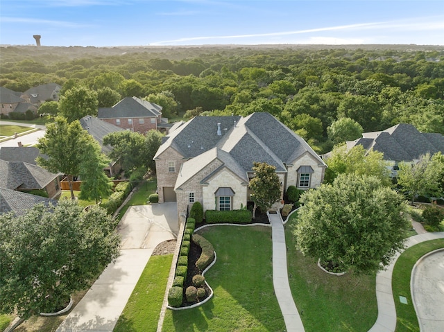 birds eye view of property with a view of trees and a residential view