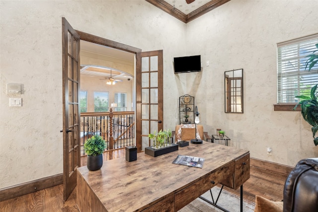 office featuring ornamental molding, a ceiling fan, wood finished floors, and a wealth of natural light