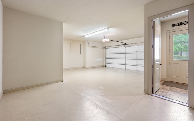 garage featuring baseboards and a garage door opener