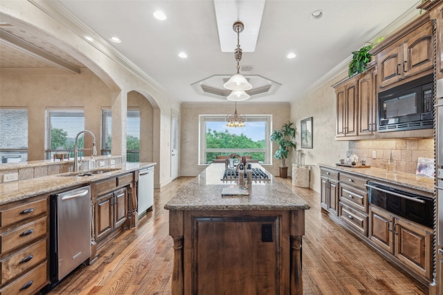 kitchen with black microwave, light stone countertops, a sink, dishwashing machine, and a warming drawer