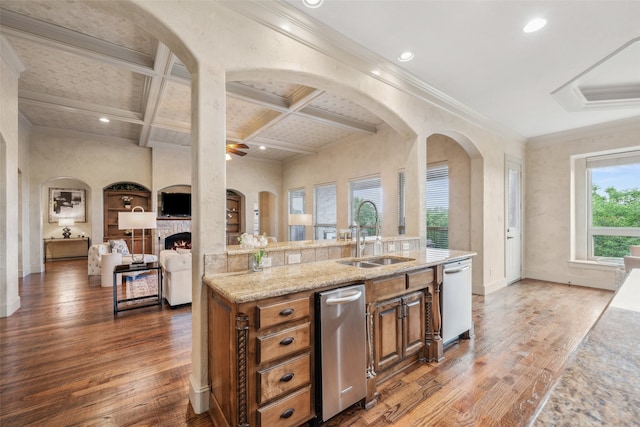 kitchen featuring arched walkways, wood finished floors, a sink, open floor plan, and coffered ceiling
