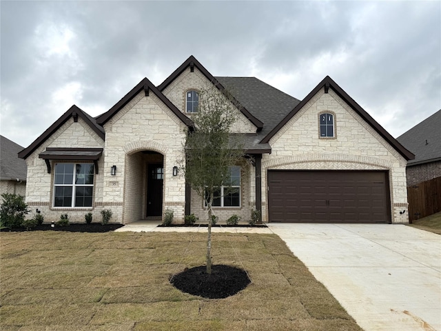 35 Magpie, Joshua, TX 76058 - french country inspired facade featuring concrete driveway, a front lawn, stone siding, and brick siding