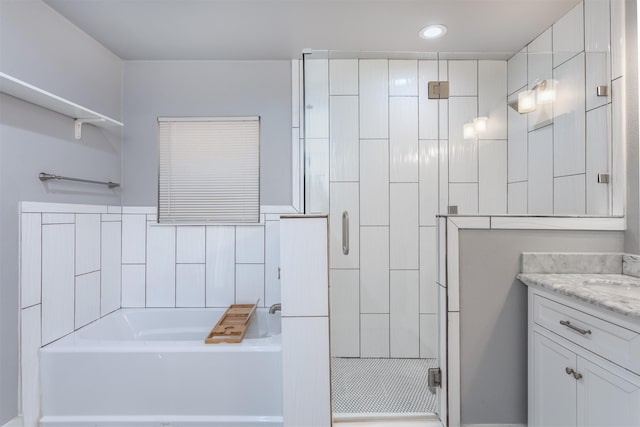 bathroom featuring recessed lighting, a shower stall, a bath, and vanity