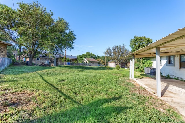 view of yard featuring cooling unit, a patio area, and fence