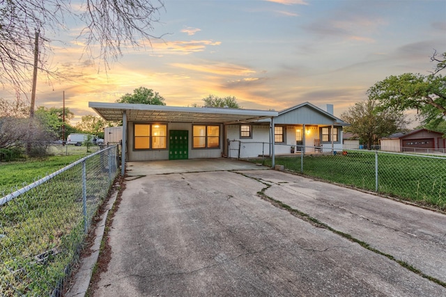 view of front facade featuring a porch, a front lawn, aphalt driveway, and a fenced front yard