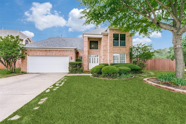 traditional home with brick siding, fence, a front lawn, and a garage