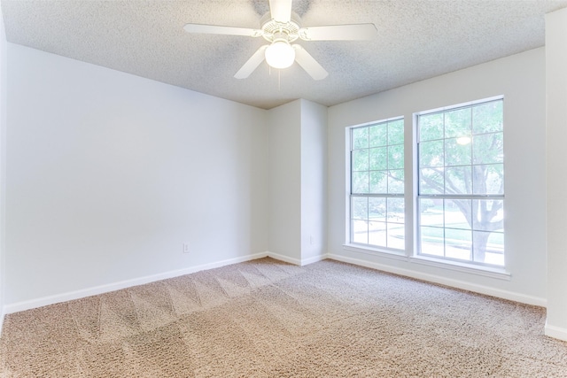 unfurnished room with baseboards, carpet flooring, and a textured ceiling