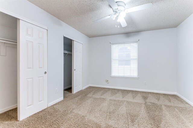 unfurnished bedroom featuring baseboards, carpet flooring, and a textured ceiling