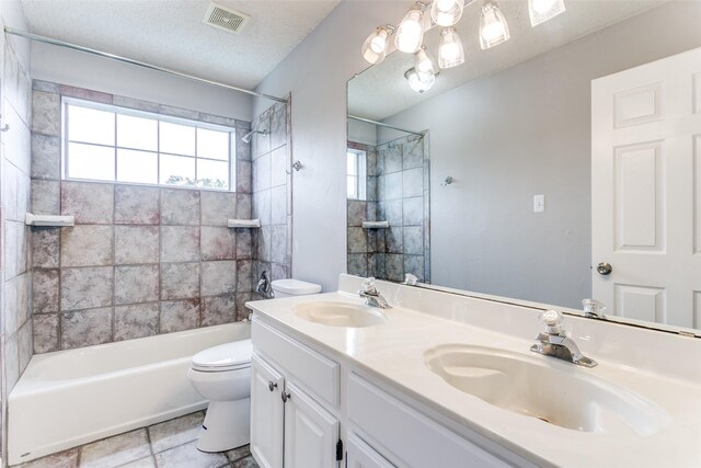 full bath with visible vents, a sink, washtub / shower combination, and toilet