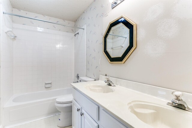 bathroom with a sink, toilet, a textured ceiling, and shower / tub combination