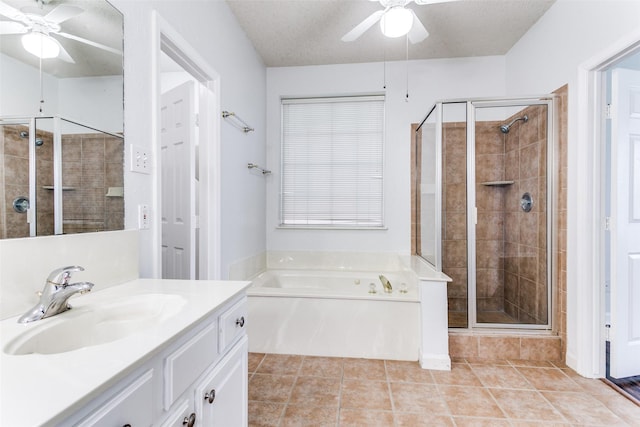 bathroom with tile patterned flooring, vanity, ceiling fan, a bath, and a shower stall