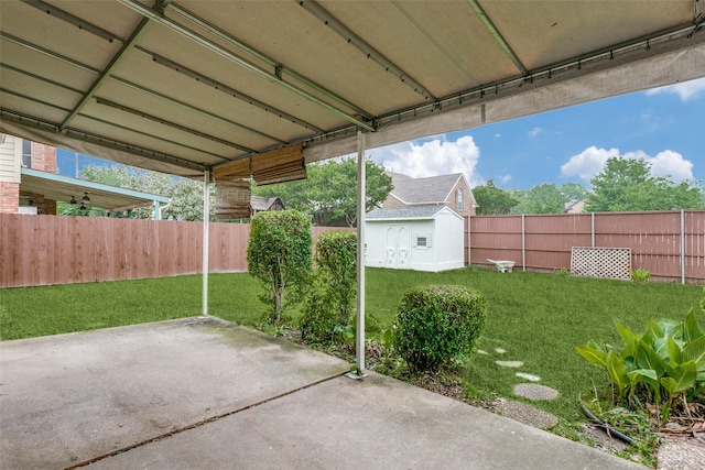 view of patio featuring a fenced backyard, an outdoor structure, and a shed