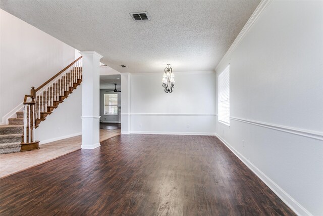 interior space with visible vents, ornamental molding, dark wood-style flooring, stairs, and ornate columns