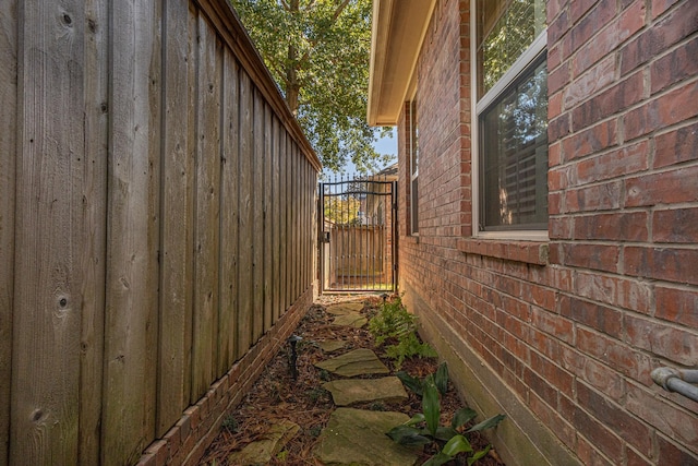 789 Fairmont Dr, Tyler, TX 75701 - view of side of home with a gate and brick siding