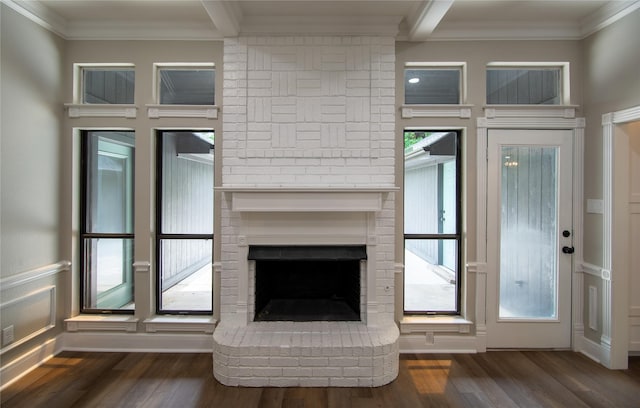 unfurnished living room with a fireplace, wood finished floors, a wealth of natural light, and crown molding