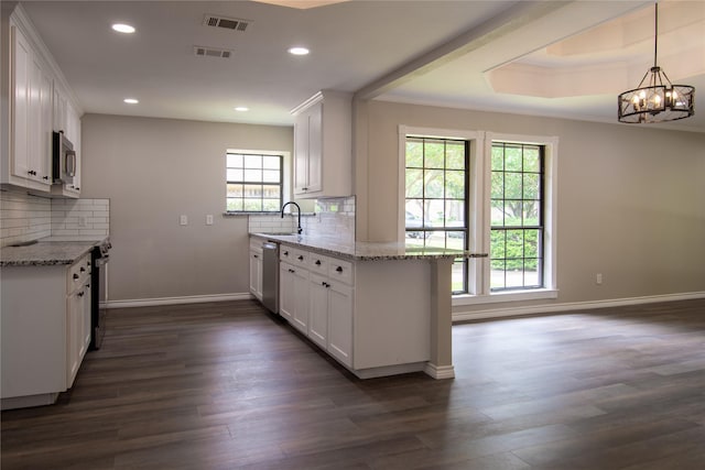 kitchen with visible vents, appliances with stainless steel finishes, white cabinetry, and a sink