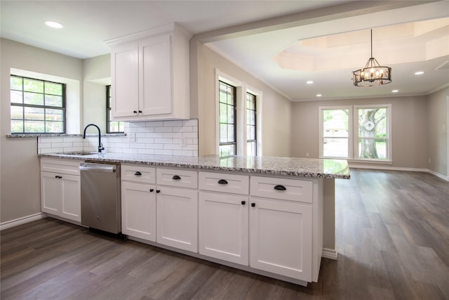 kitchen with stainless steel dishwasher, dark wood-style flooring, a sink, a peninsula, and white cabinetry