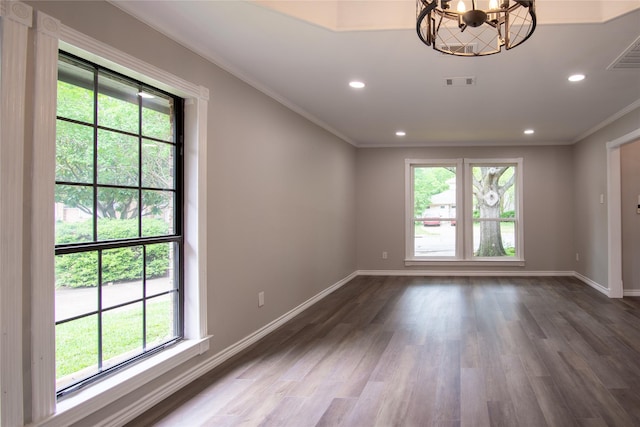 spare room featuring visible vents, crown molding, a wealth of natural light, and an inviting chandelier