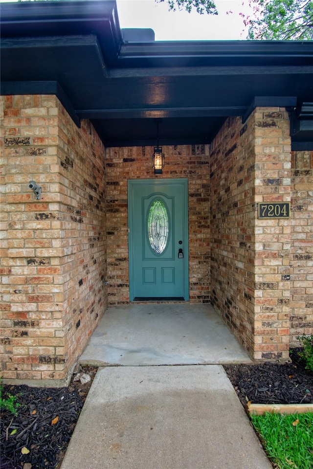 doorway to property with brick siding