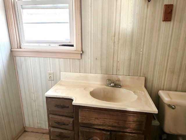 half bathroom with toilet and vanity