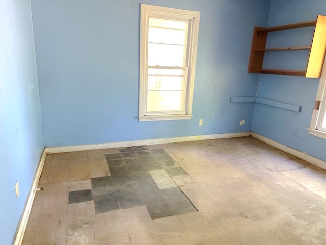 empty room featuring baseboards