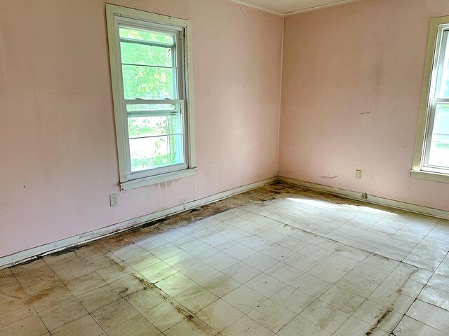 unfurnished room featuring baseboards