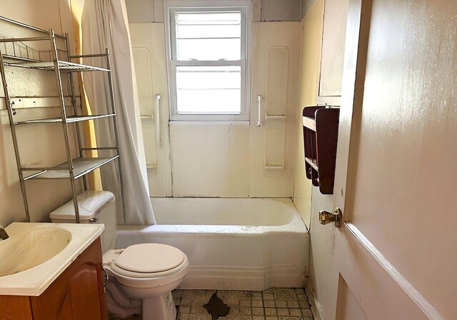 bathroom with toilet, vanity, and shower / bathtub combination with curtain