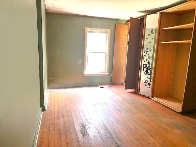 unfurnished bedroom with wood-type flooring