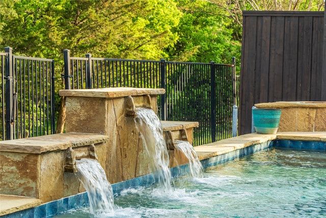 exterior details with fence and a swimming pool