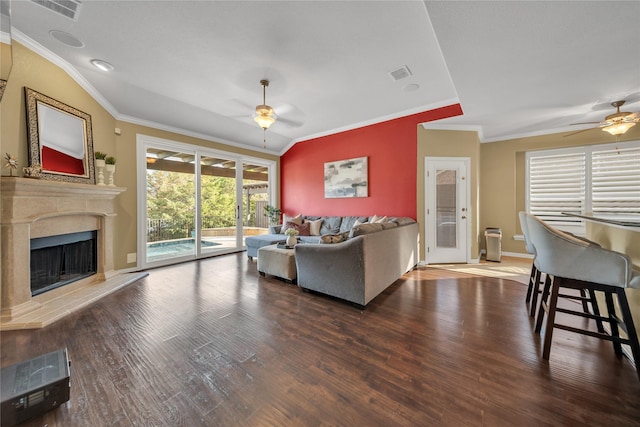 living area with ornamental molding, a ceiling fan, and visible vents