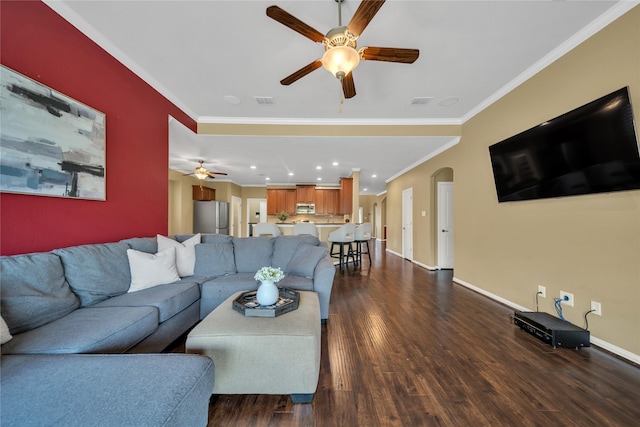 living area with baseboards, a ceiling fan, dark wood-style floors, and ornamental molding