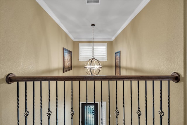 details featuring visible vents, an inviting chandelier, and ornamental molding