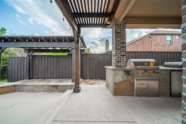 view of patio / terrace with a fenced backyard, a pergola, grilling area, and exterior kitchen