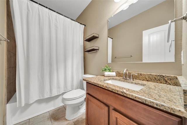 full bath with tile patterned floors, shower / bath combo with shower curtain, vanity, and toilet