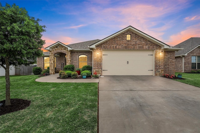 ranch-style house featuring a front lawn, roof with shingles, concrete driveway, brick siding, and a garage