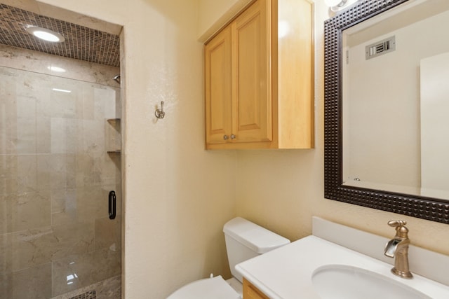 full bath with toilet, vanity, and a stall shower