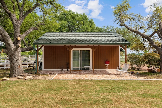 rear view of house featuring fence, a yard, and a patio