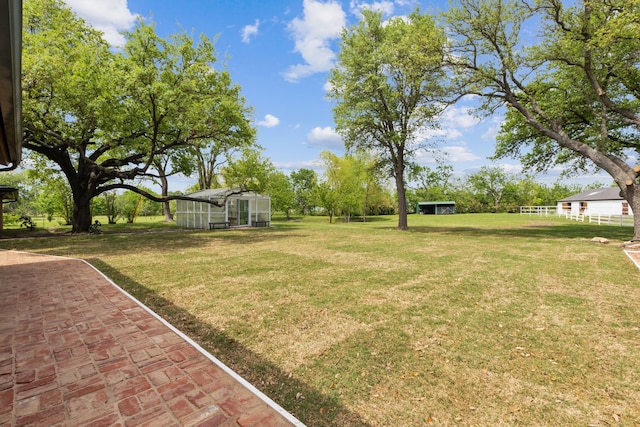 view of yard with an outdoor structure and a greenhouse