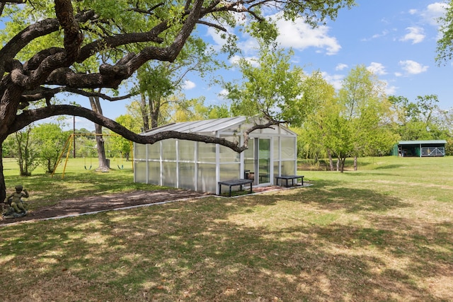 view of yard with an outdoor structure and a greenhouse