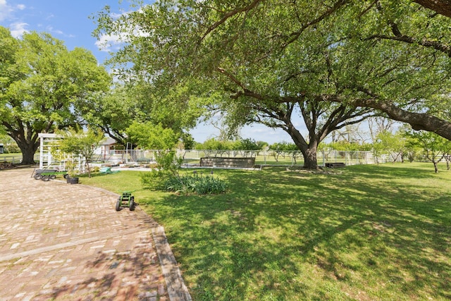 view of home's community featuring a lawn and fence