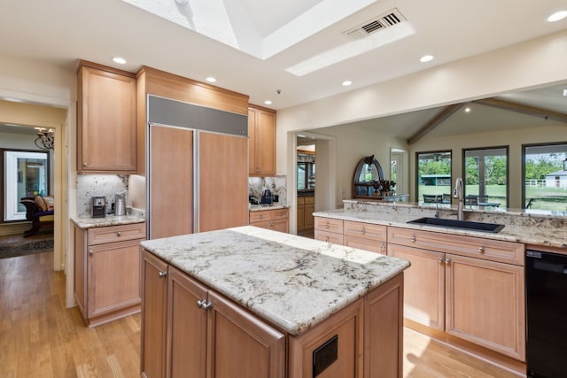 kitchen with a sink, vaulted ceiling with beams, black dishwasher, visible vents, and a kitchen island