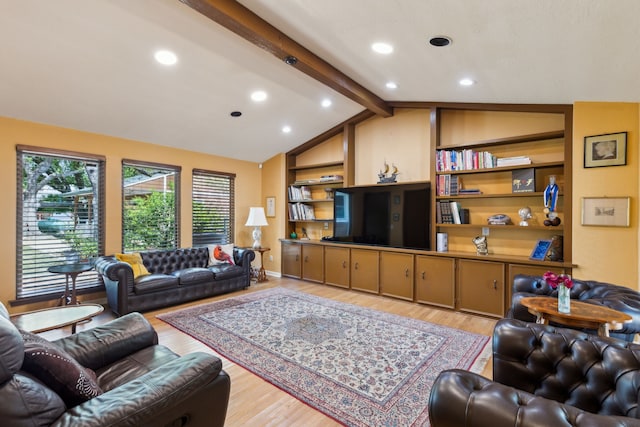 living area with light wood-type flooring, lofted ceiling with beams, and built in shelves
